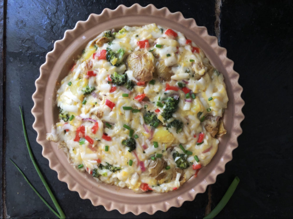 loaded potato casserole with a black background