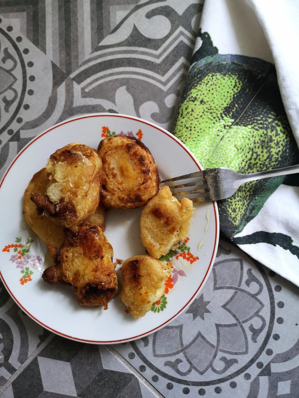 crispy fried bananas on a plate with a fork