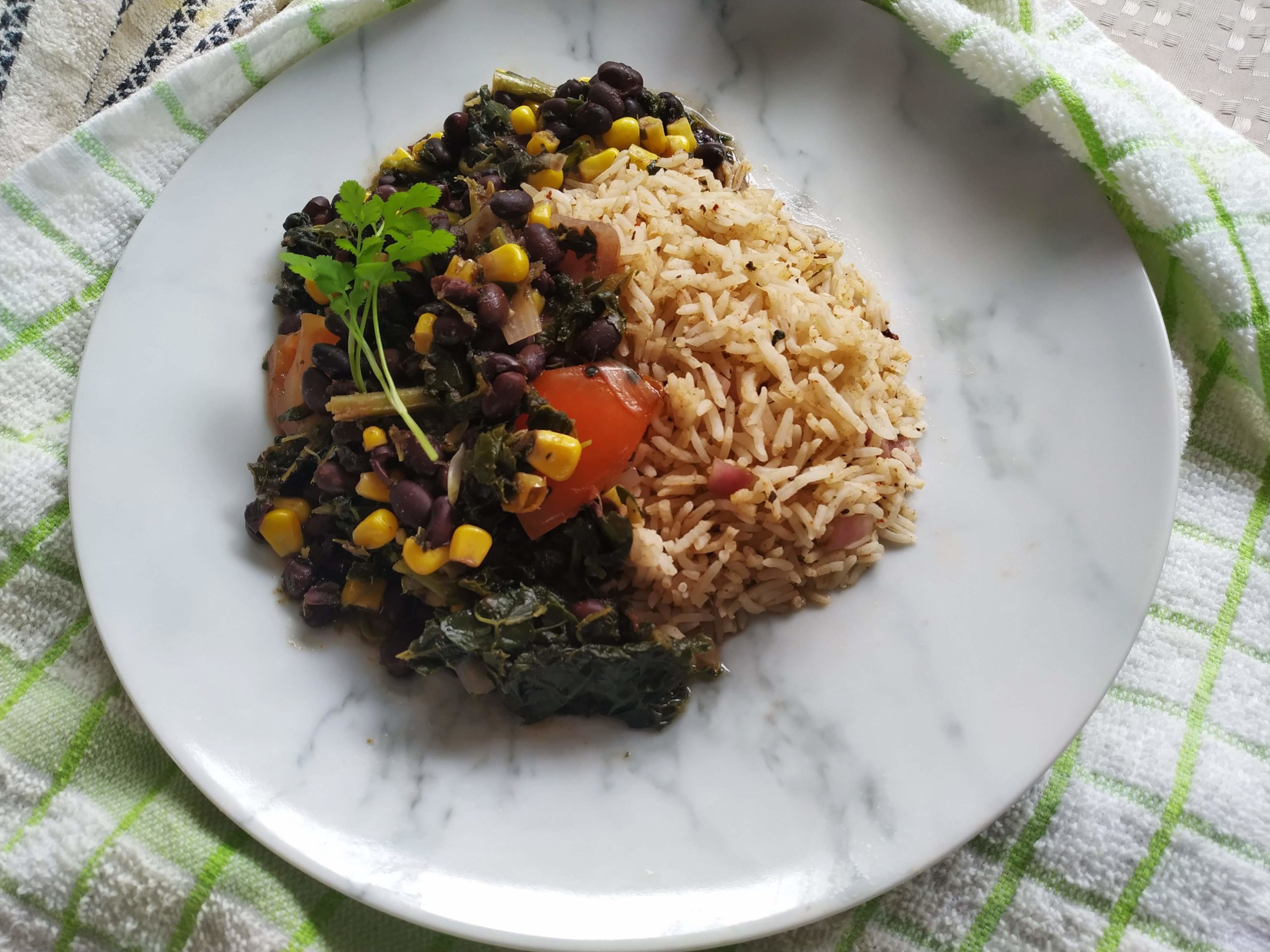 sweet potato kale black bean chili on a white plate