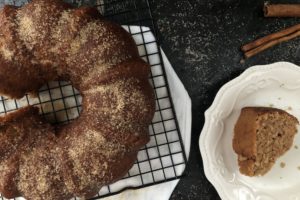 vegan apple cider bundt cake on a cooling rack and on a plate