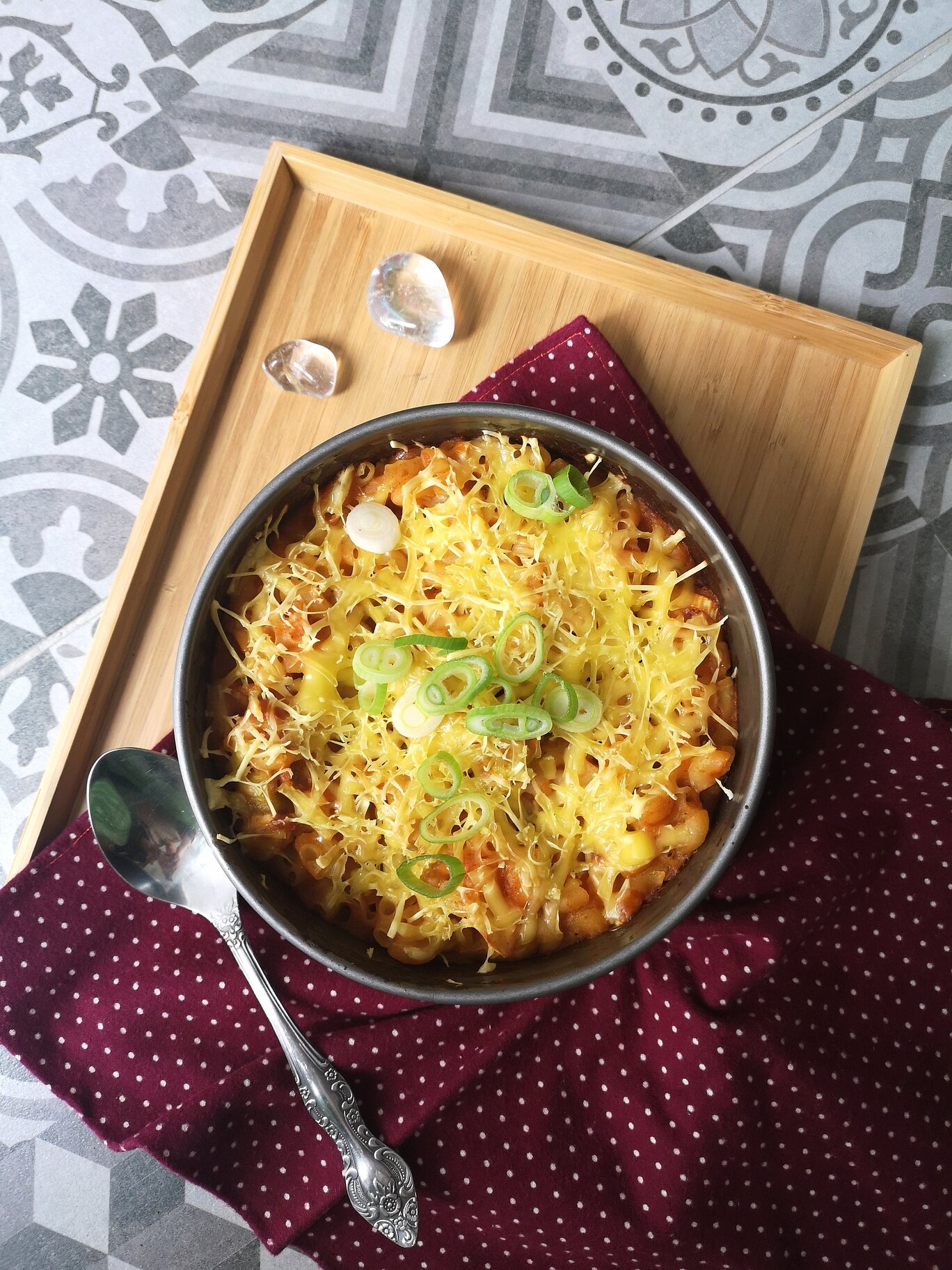 vegna kimchi mac n cheese on a white plate with a spoon