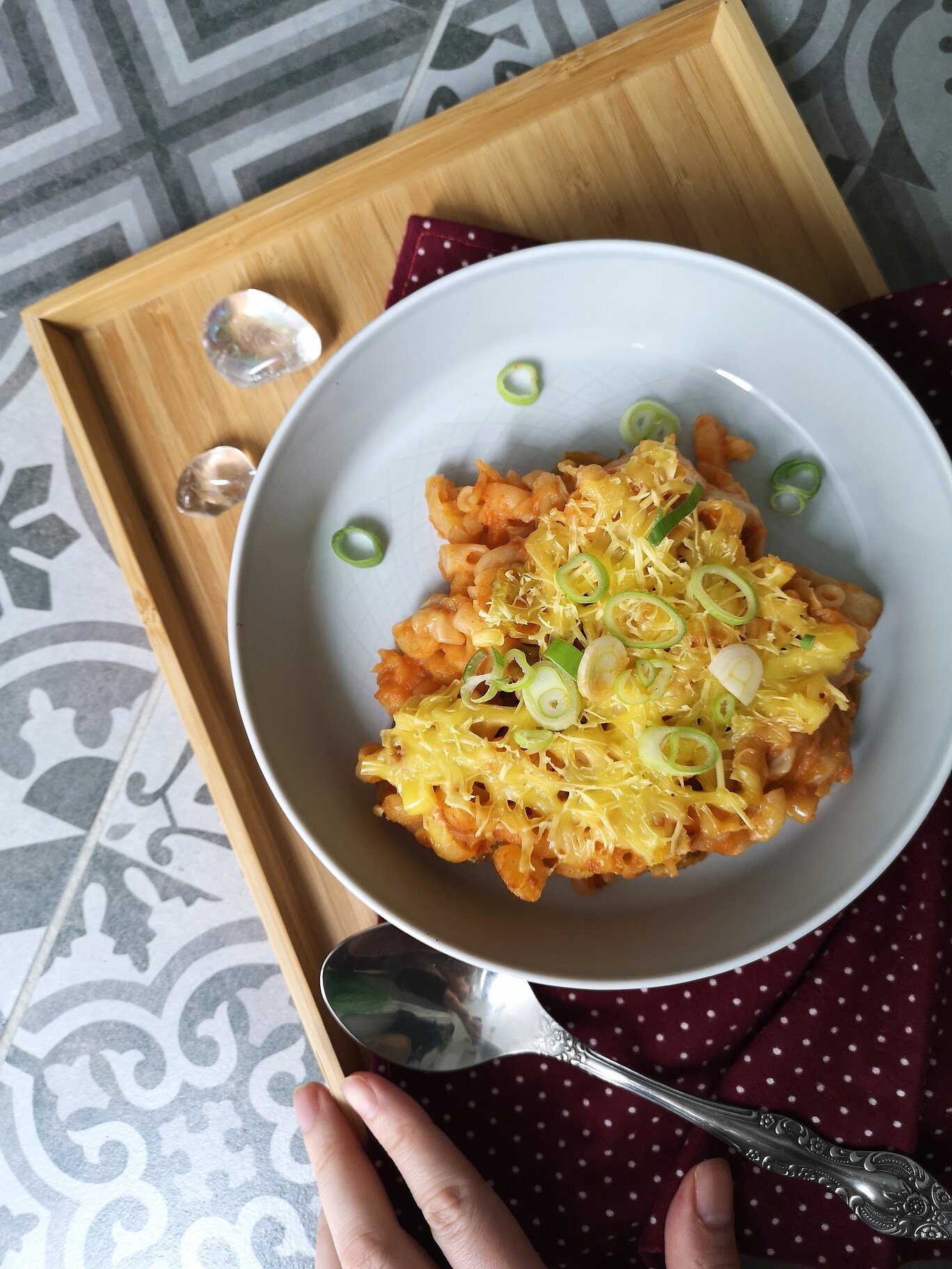 vegna kimchi mac n cheese on a white plate with a spoon