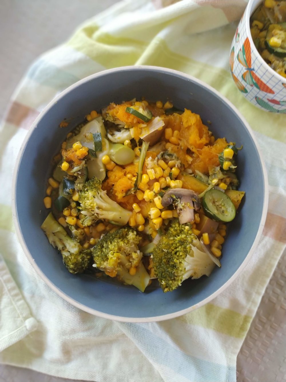 pumpkin stew with broccoli, corn, and mushrooms in a bowl