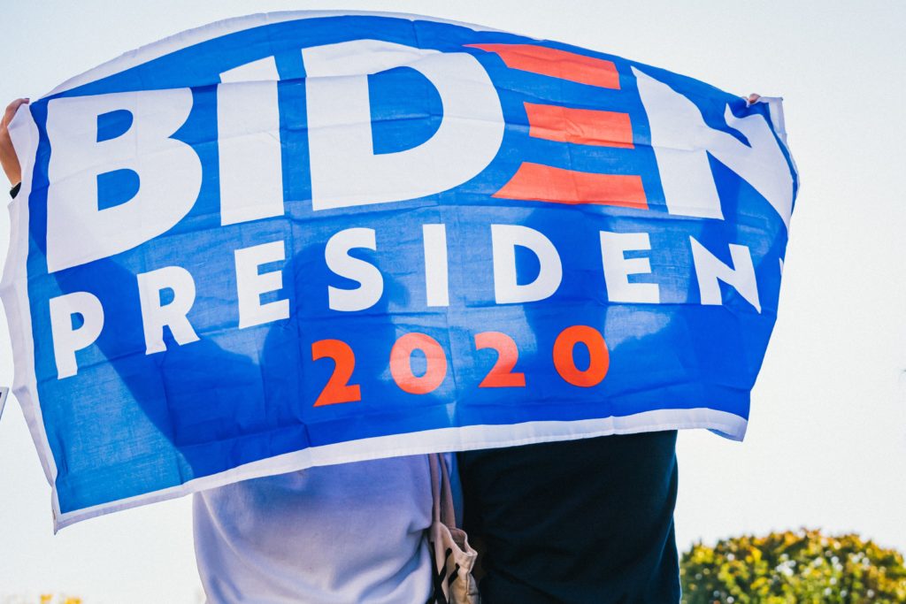 Two people holding up a Biden 2020 President flag