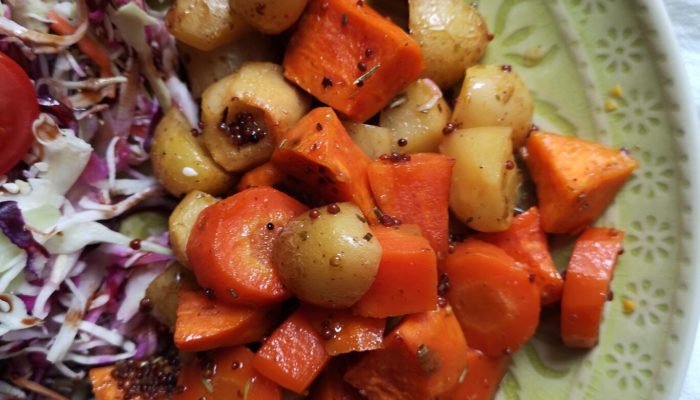 cider roasted root vegetables on a green plate