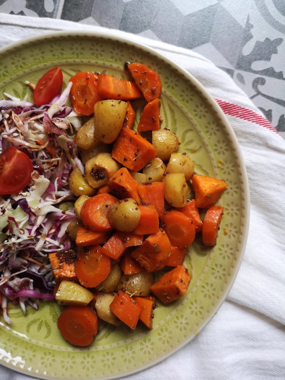 cider roasted root vegetables on a green plate