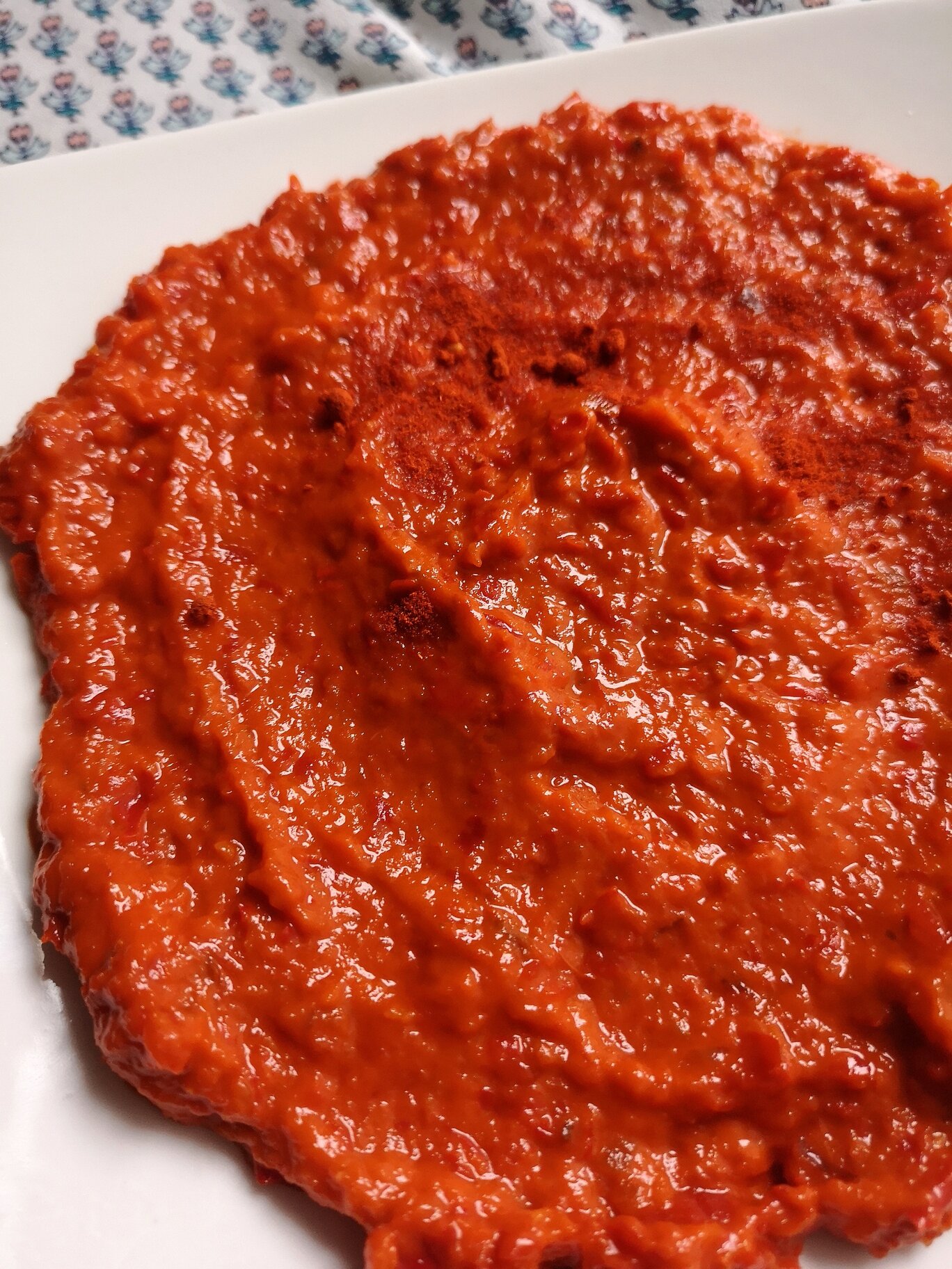 vegan homemade ajvar; roasted pepper spread on a white plate