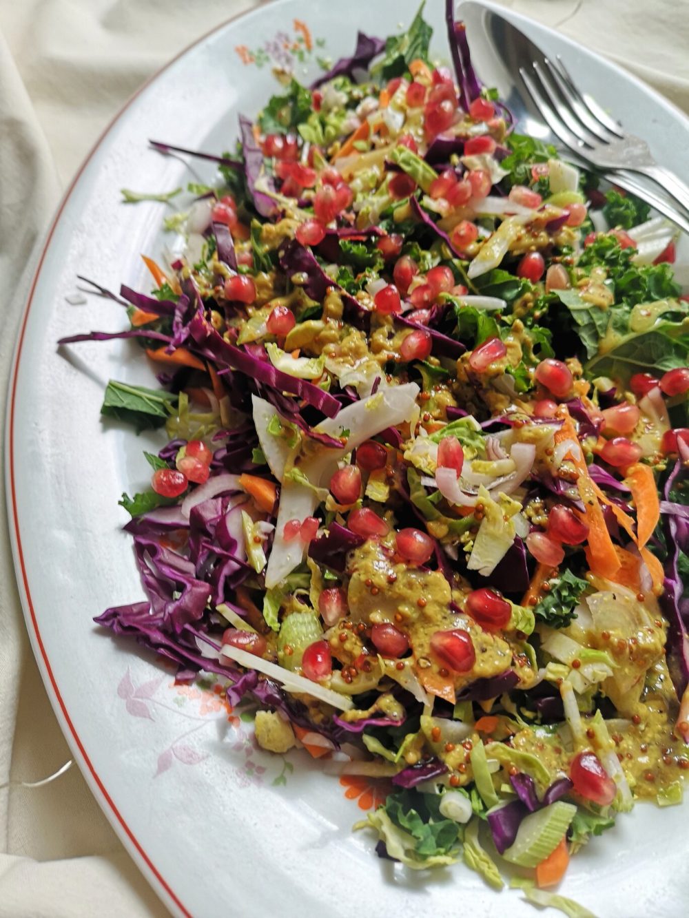 brussels sprout slaw on a white plate with a fork