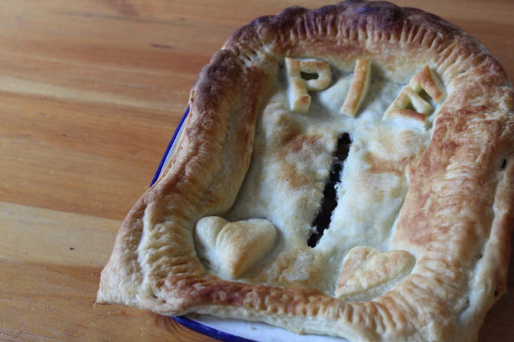 vegan mushroom and ale pie on a wooden table