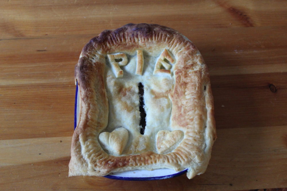 vegan mushroom and ale pie on a wooden table