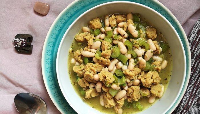 vegan persian celery stew in a bowl with a spoon and crystals