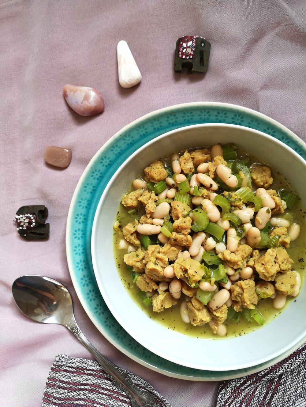 vegan persian celery stew in a bowl with a spoon and crystals