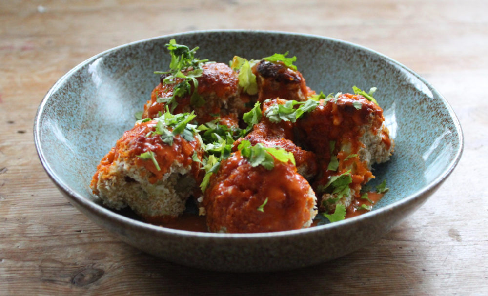 cauliflower wings on a plate on a table