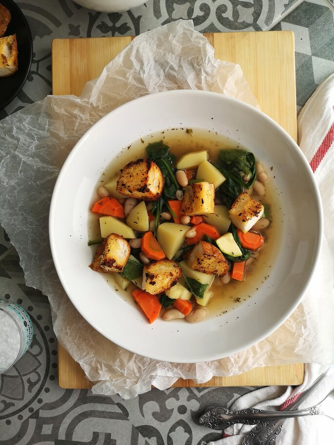 tuscan potato soup in a white bowl