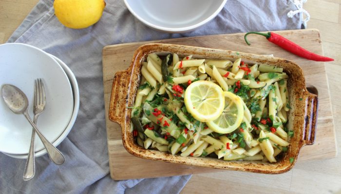 vegan zucchini and roasted lemon pasta in a dish on a cutting board