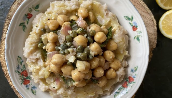 vegan chickpea picatta in a dish against a brown and black background