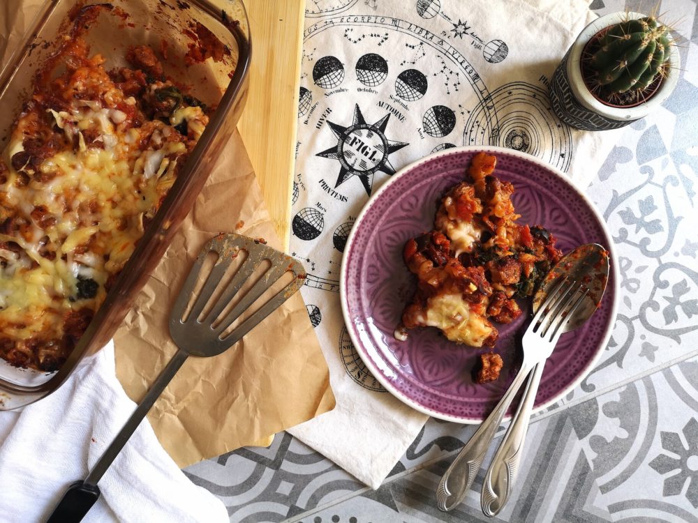 a vegan pasta dish with a serving on a plate next to a cactus