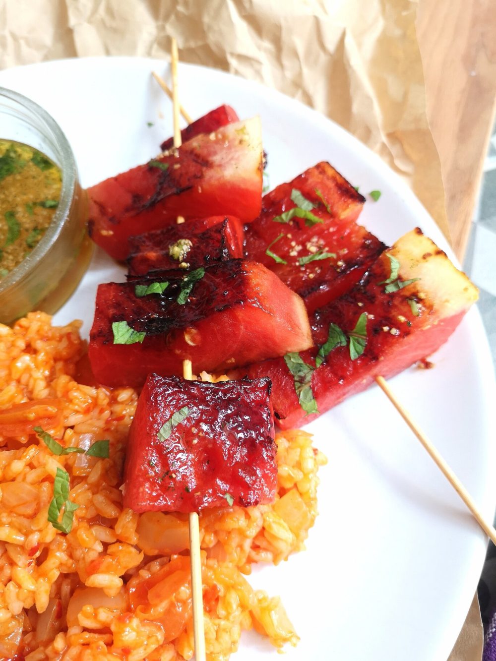 grilled watermelon and turkish rice on a white plate