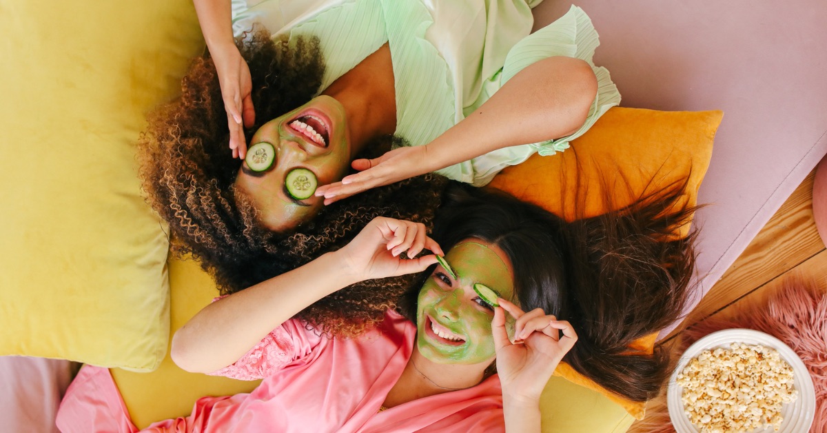 girls smiling with cucumbers on their eyes