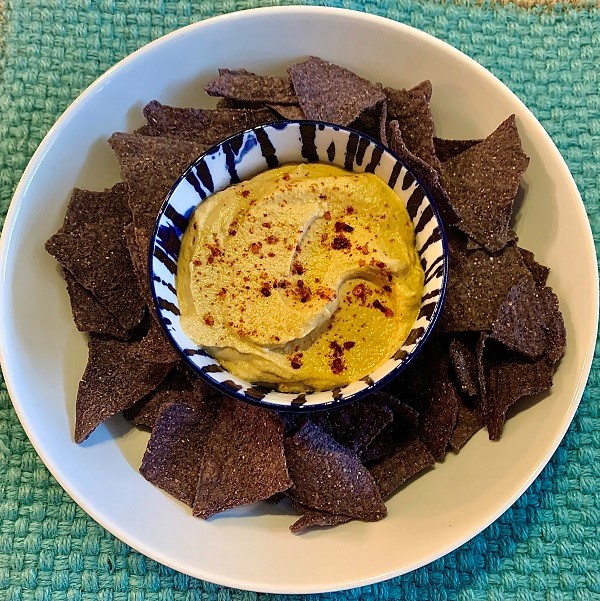 Sunflower seed queso dip with blue corn tortilla chips