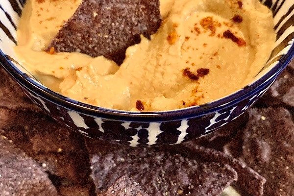 Sunflower seed queso dip with blue corn tortilla chips