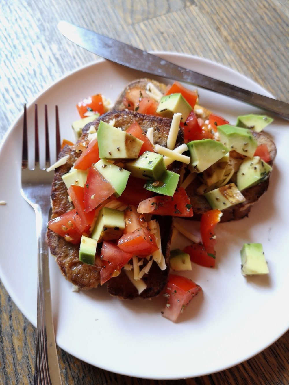 vegan mexican style "eggy" bread on a white plate with silverware