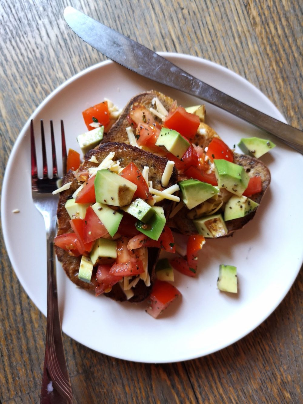 vegan mexican style "eggy" bread on a white plate with silverware