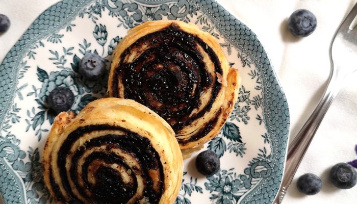 vegan chocolate rolls on a blue and white plate next to a fork