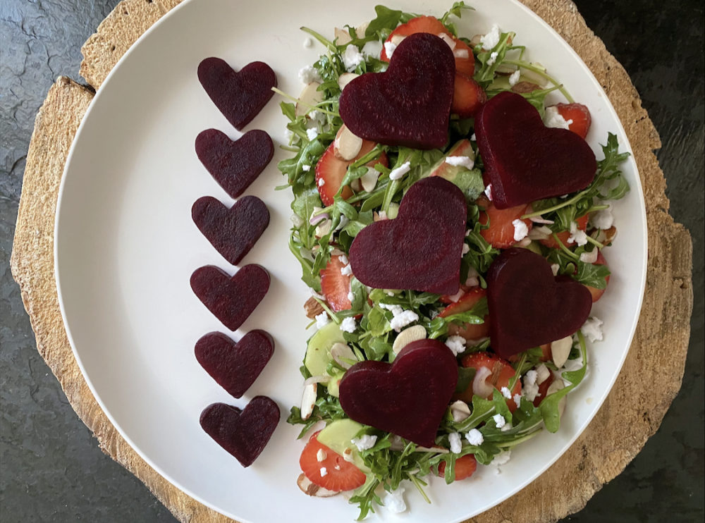 beet salad on a white plate with brown and black background