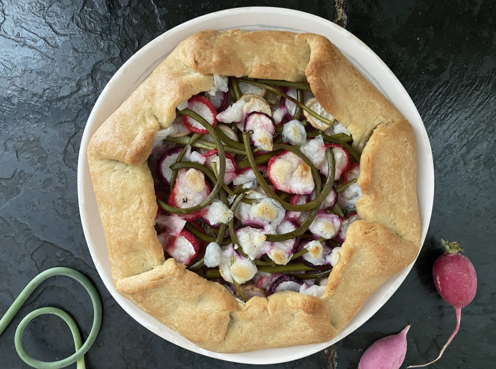 galette on a white plate against a black background