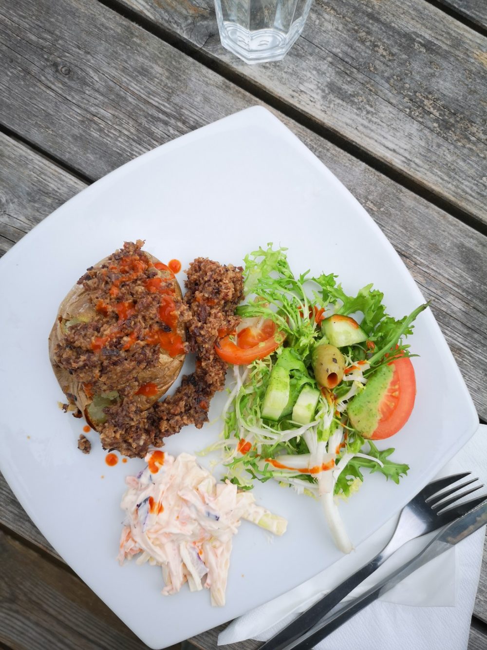 vegan haggis on a white plate on a wooden table top