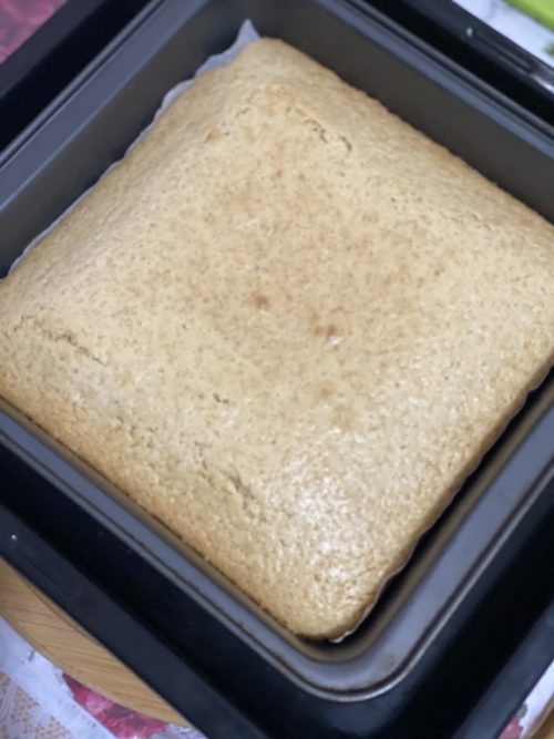 a square black pan of cake