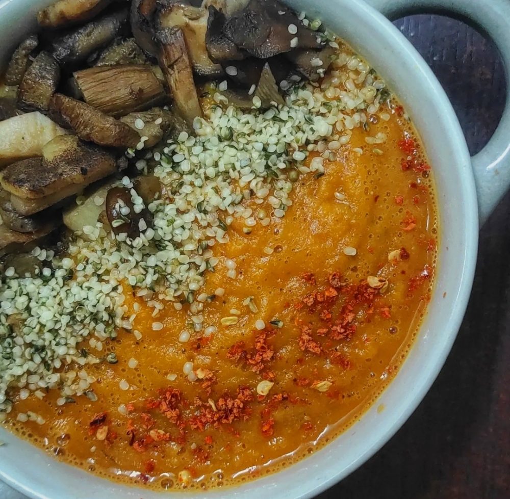 toasted tomato pumpkin soup in a white bowl