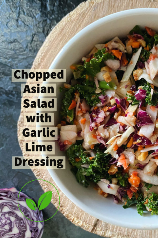 chopped asian salad in a white bowl against a brown and black background