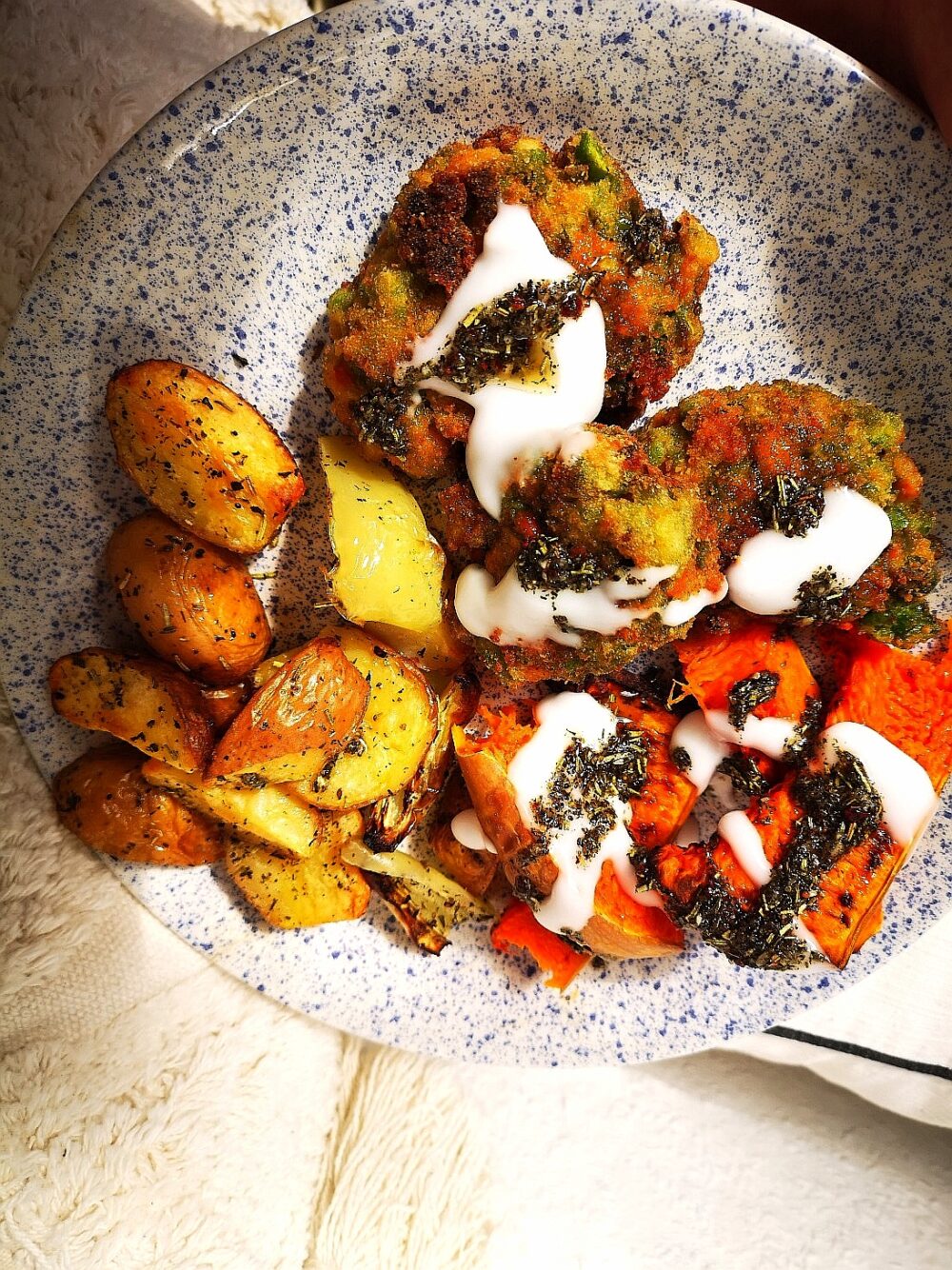 a speckled black and white plate holding vegan pea croquettes