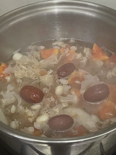 soup ingredients cooking in a silver pot