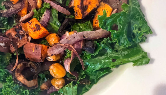 sweet potato kale salad in a white dish