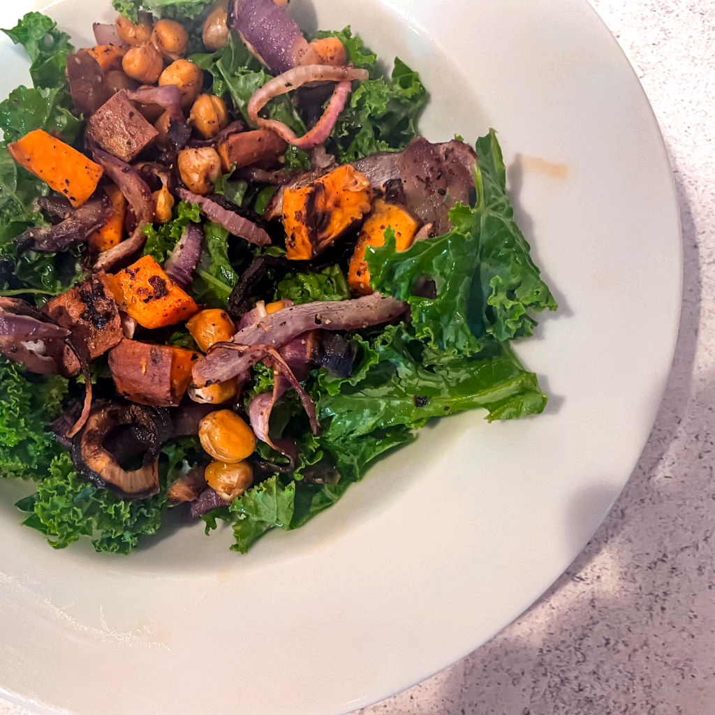 sweet potato kale salad in a white dish