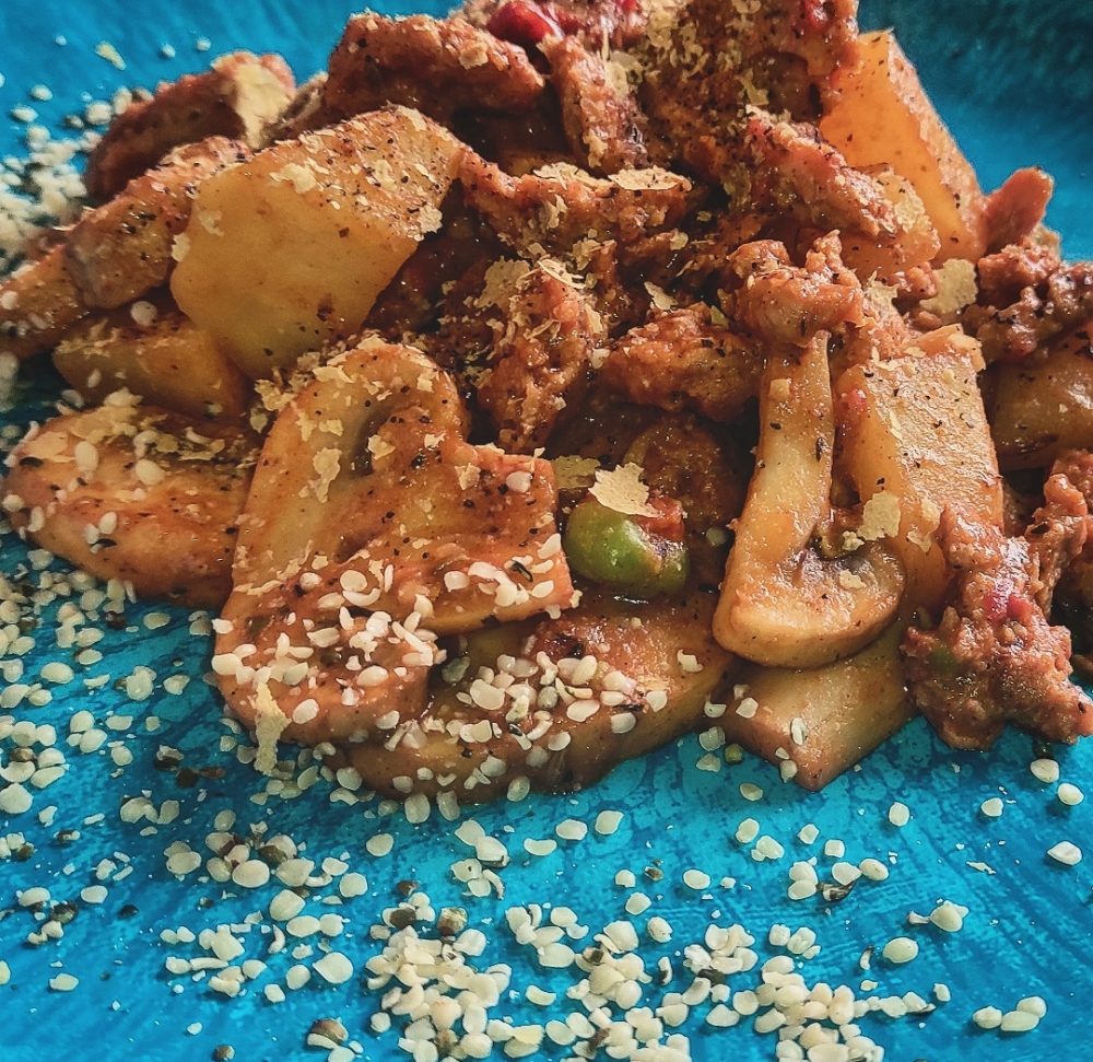 vegan meaty stew on a blue plate