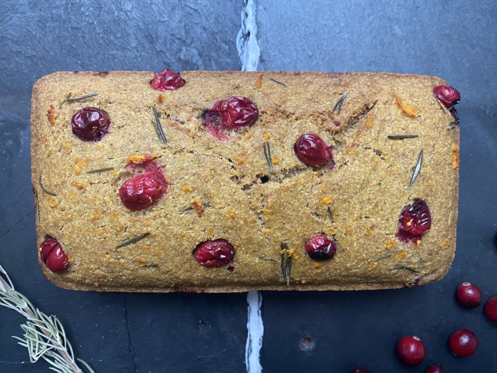 vegan cranberry cornbread against a dark background