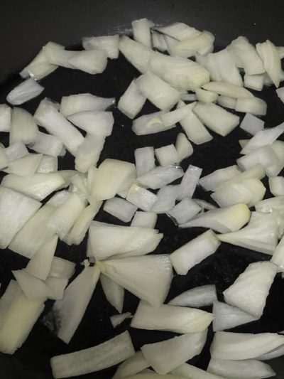 chopped white onion in a pan