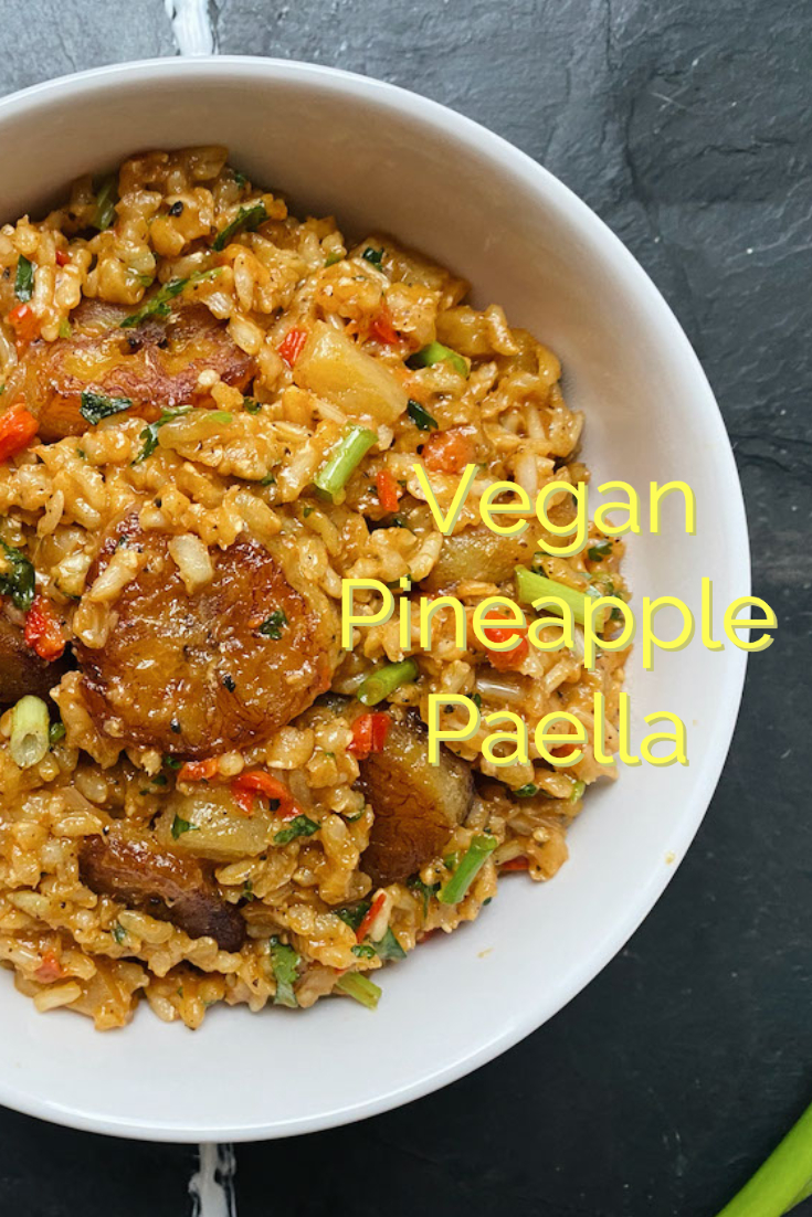 vegan pineapple paella in a white dish with caption on a black background