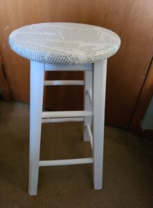 a stool decorated with book pages