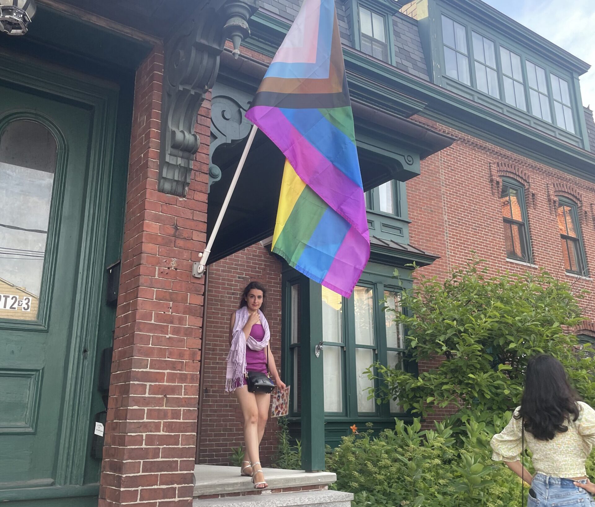 woman walking out of a store with a price flag